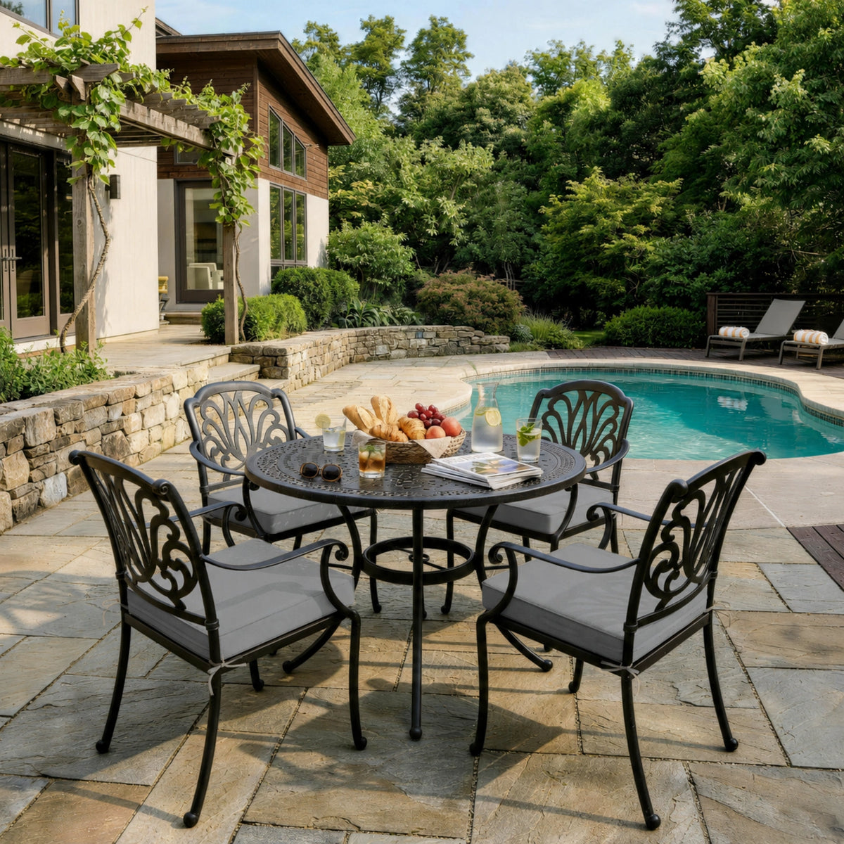 Light Gray outdoor seat cushions on patio chairs with a round outdoor dining table in a backyard setting.
