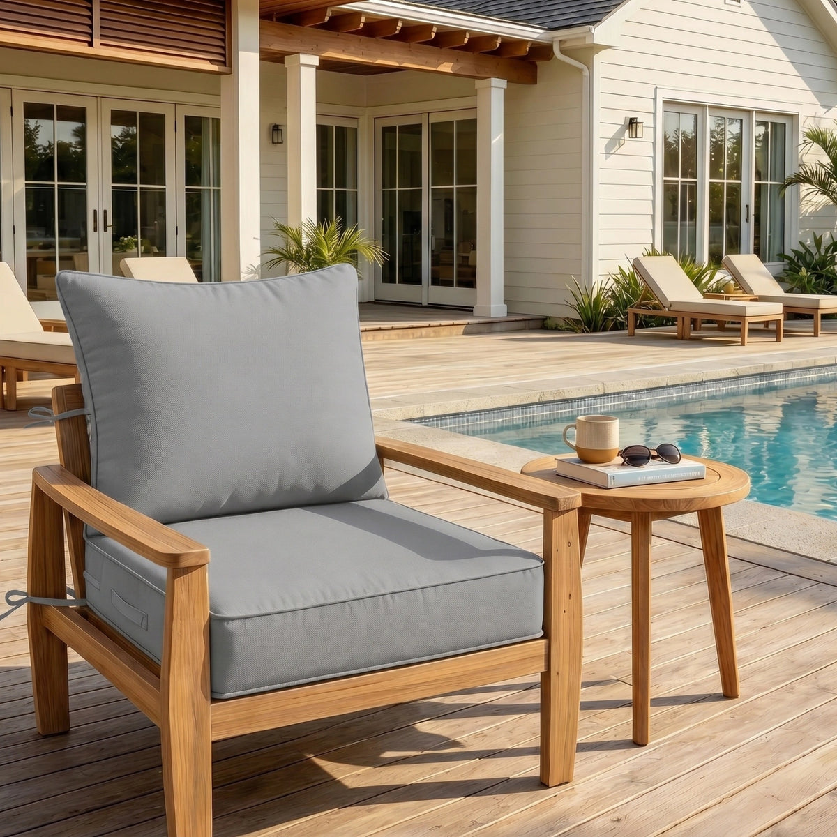 Light Gray outdoor deep seat cushion on patio chair with poolside outdoor furniture setting.