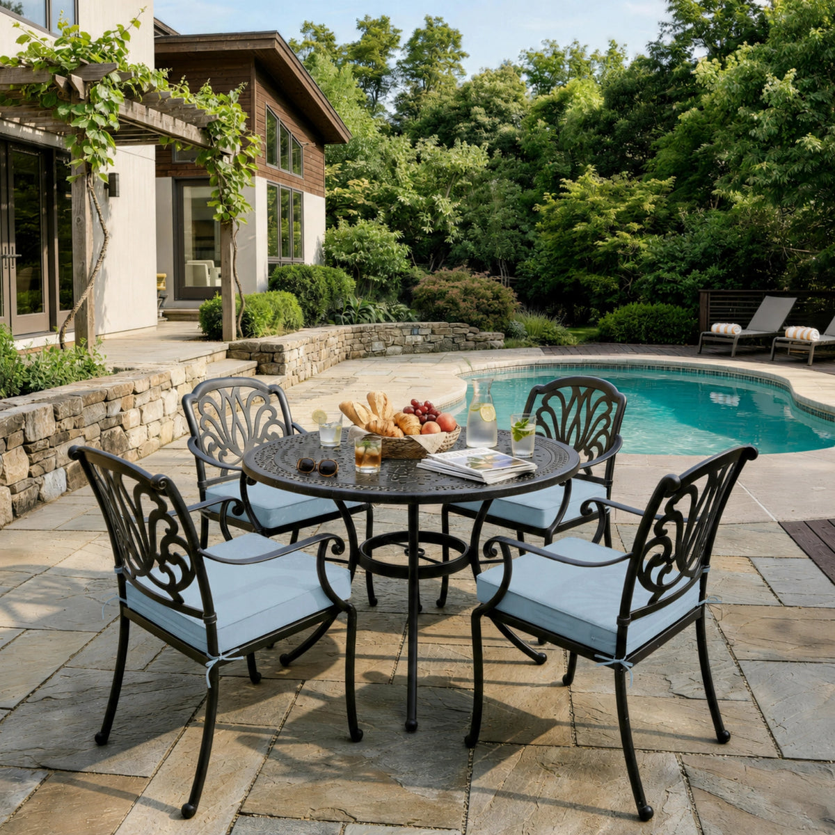 Sky Blue outdoor seat cushions on patio chairs with a round outdoor dining table in a backyard setting.