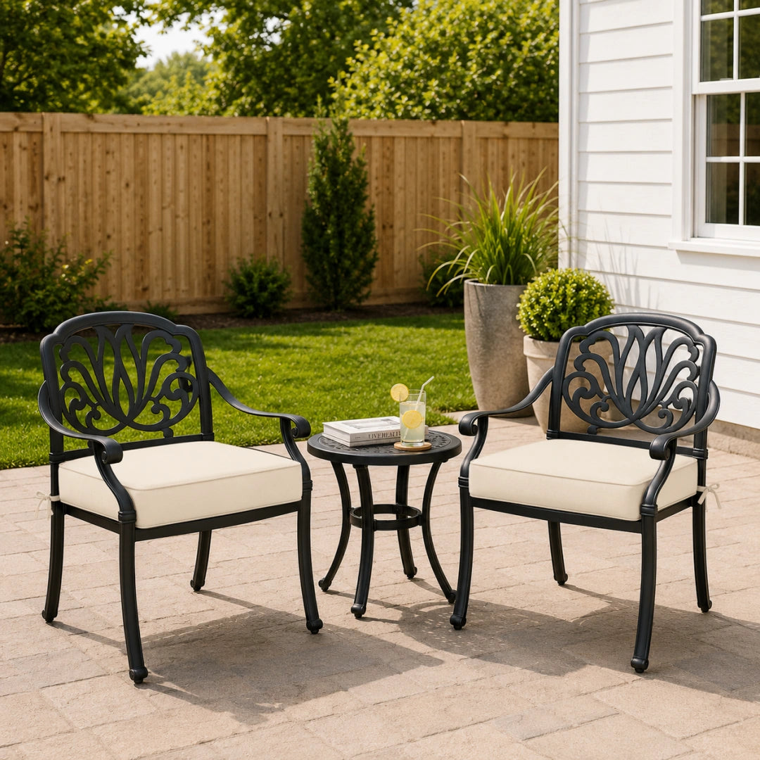 deep outdoor seat cushions in cream on black metal patio chairs, styled in a clean backyard seating area