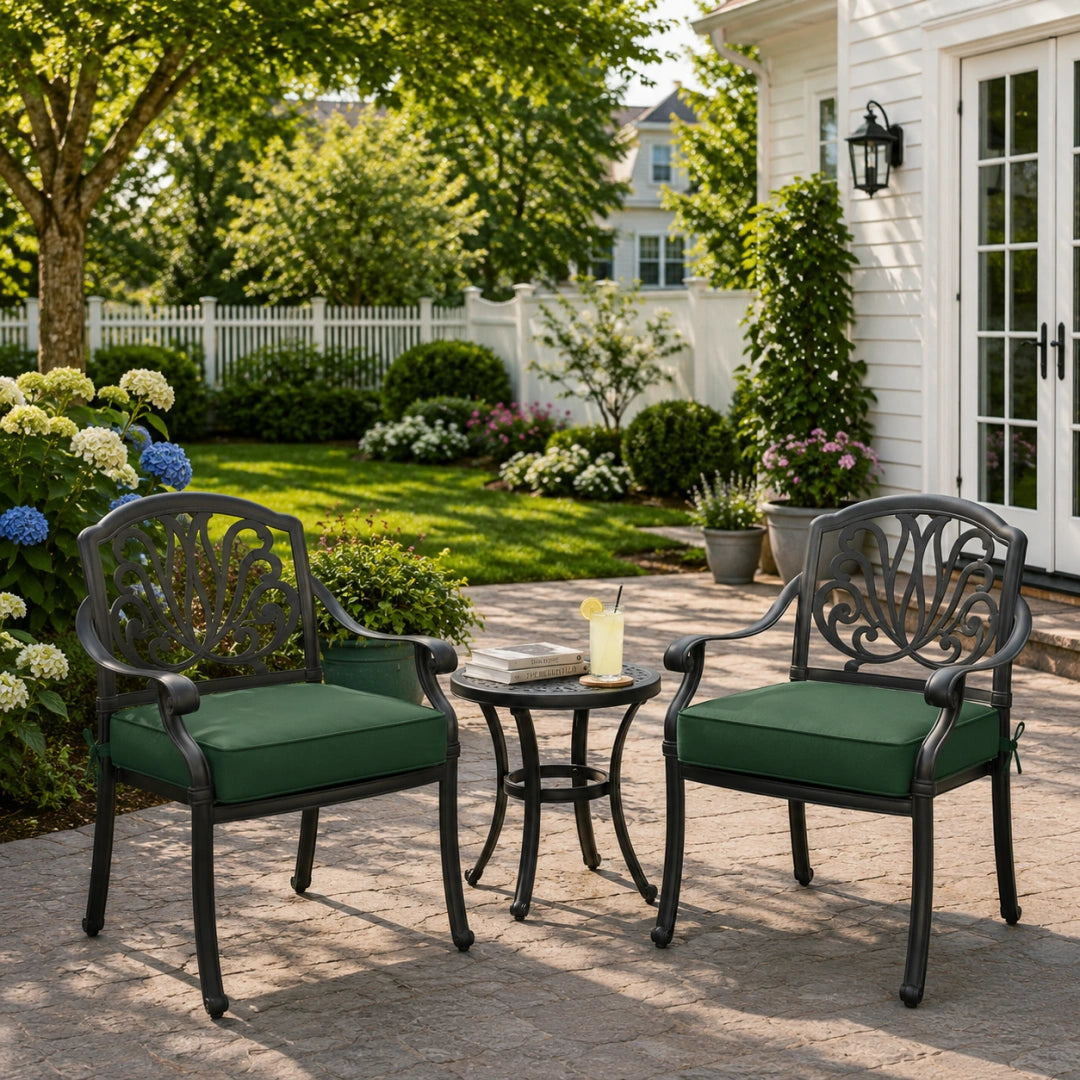 deep seat outdoor cushion in dark green on black metal patio chairs, shown in a sunny outdoor garden setting