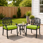 outdoor seat cushions in grass green on black metal patio chairs, styled in a sunny backyard garden with a small outdoor side table
