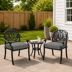 
outdoor seat cushions in light-gray on black metal patio chairs, styled in a sunny backyard garden with a small outdoor side table