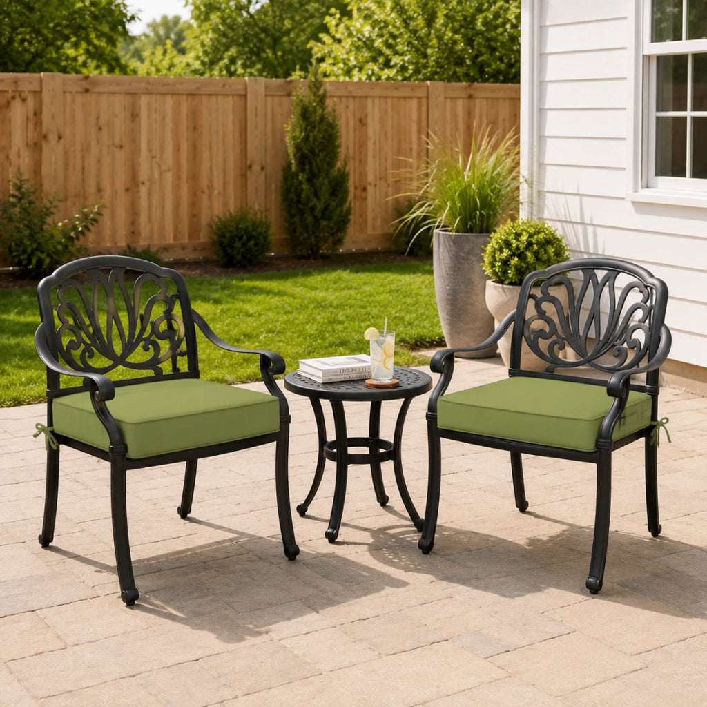 outdoor seat cushions in light green on black metal patio chairs, styled in a sunny backyard garden with a small outdoor side table