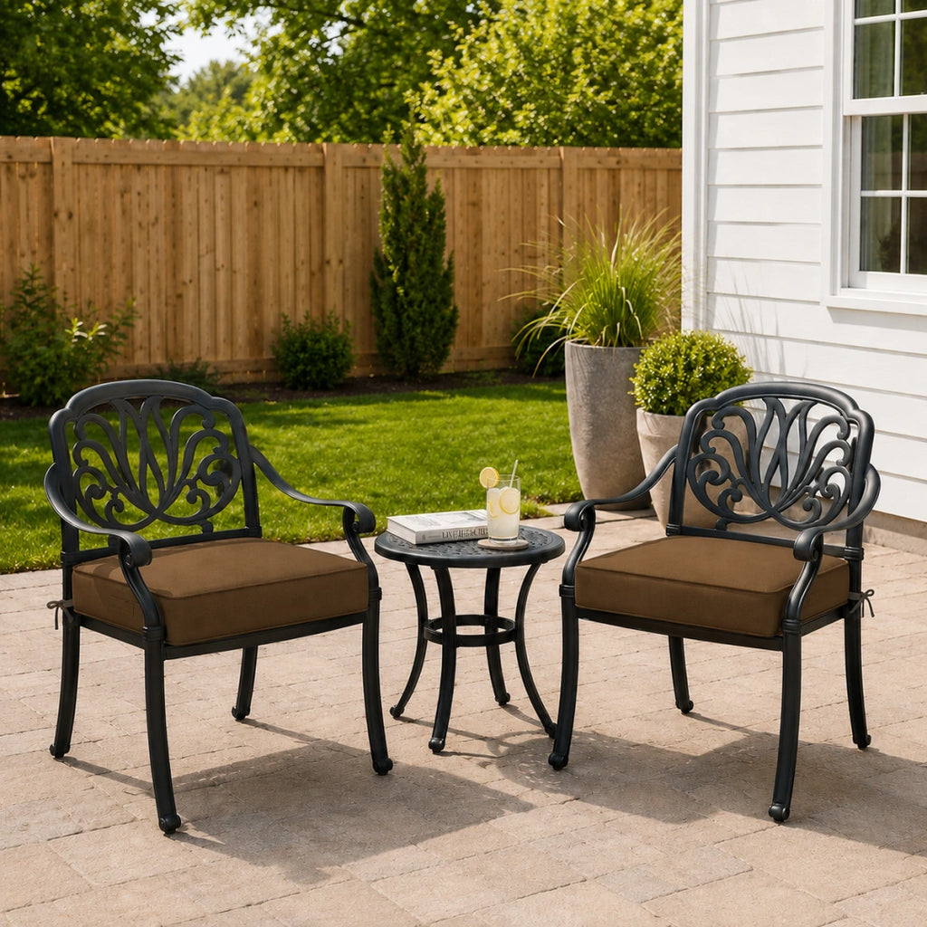 outdoor patio seat cushion in brown on two black metal patio chairs with a small round table in between
