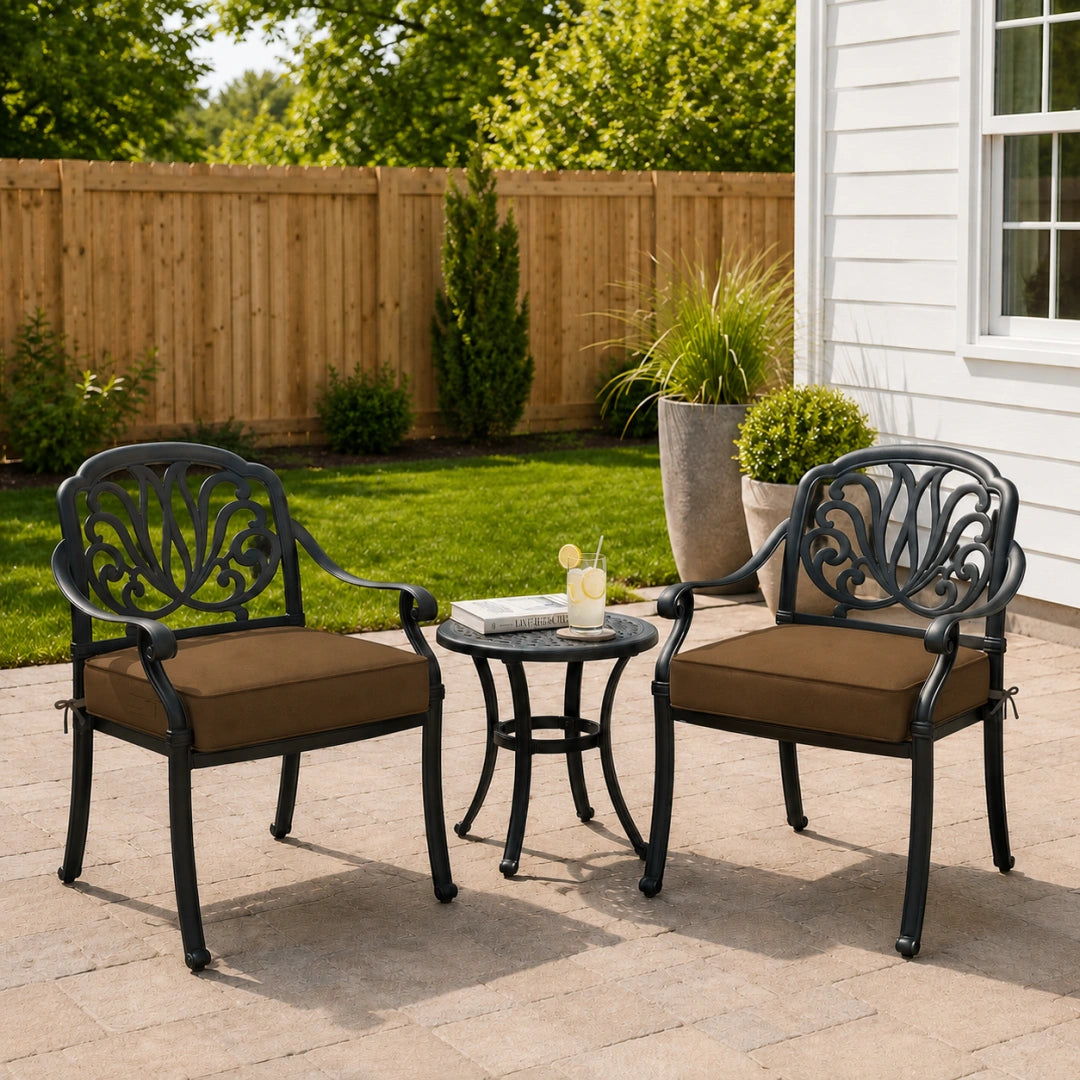 outdoor patio seat cushion in brown on two black metal patio chairs with a small round table in between

