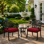 outdoor rocking chair seat cushions in burgundy red, shown on black metal patio chairs in a backyard garden scene