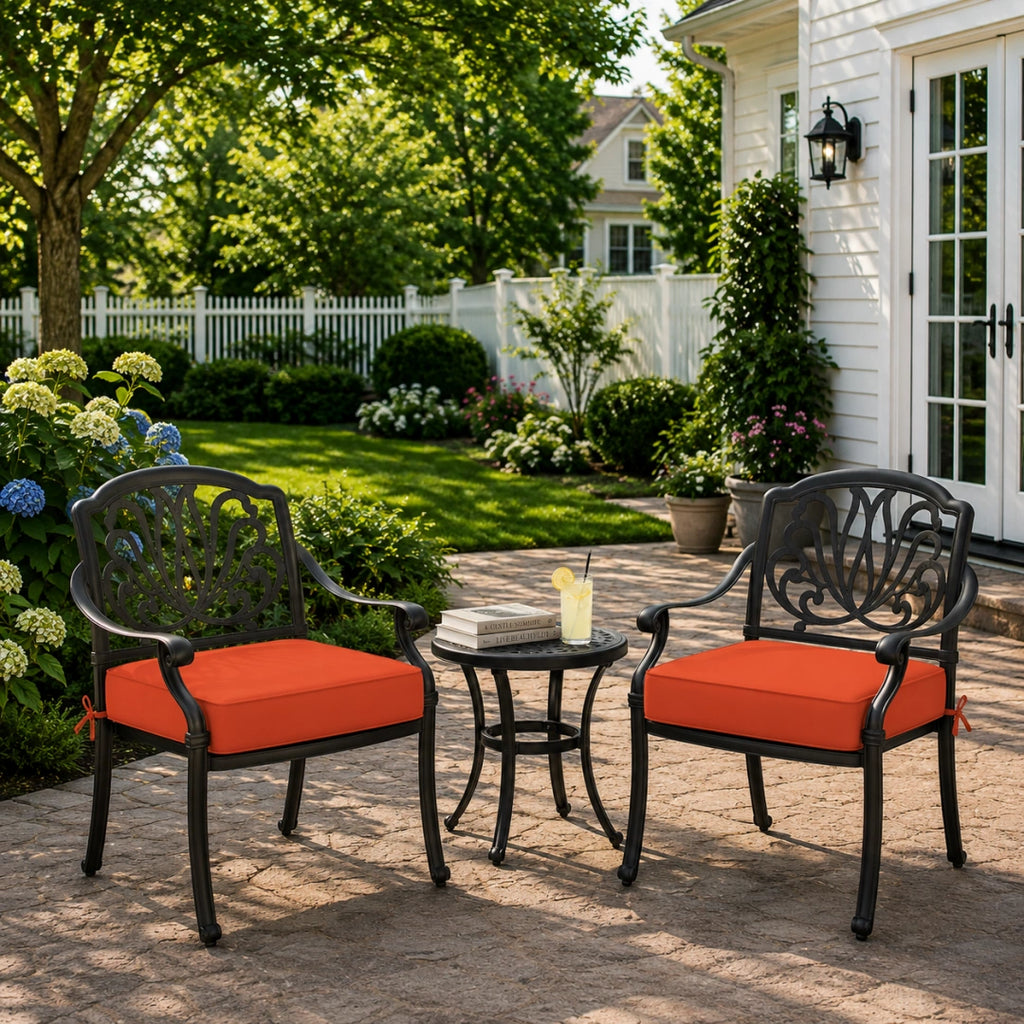 outdoor seat cushion in orange red on black metal patio chairs, creating a bright backyard patio furniture look