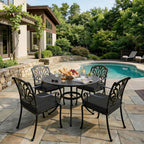 outdoor seat cushions in black on black metal patio dining chairs, styled around a round outdoor table beside a backyard pool