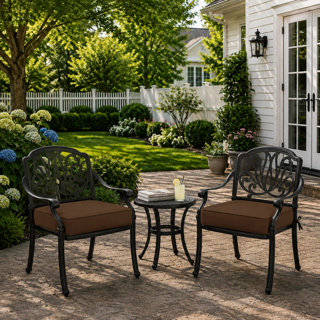 outdoor seat cushions in brown on black metal patio chairs, styled in a sunny backyard garden with a small outdoor table