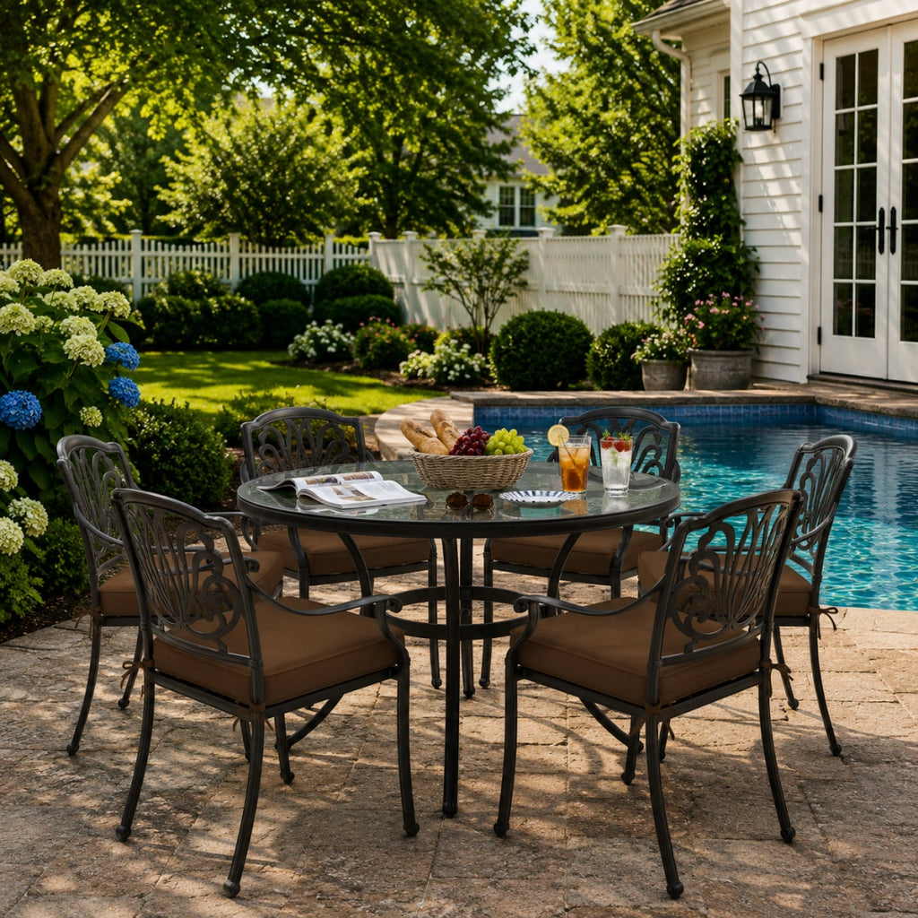 outdoor seat cushions in brown on black metal patio chairs, styled in a sunny backyard garden with a small round outdoor table