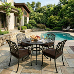 outdoor seat cushions in brown on black metal patio dining chairs, styled around a round table beside a backyard pool