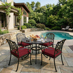 outdoor seat cushions in burgundy on black metal patio chairs, styled around a round dining table in a backyard pool area