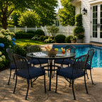 outdoor seat cushions in dark blue on black metal patio chairs, styled in a sunny backyard garden with a small round outdoor table