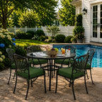 outdoor seat cushions in dark green on black metal patio chairs, styled in a sunny backyard garden with a small round outdoor table