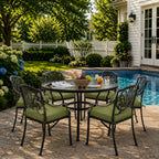 outdoor seat cushions in dark green on black metal patio chairs, styled in a sunny backyard garden with a small round outdoor table