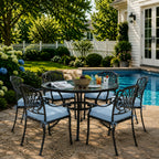 outdoor seat cushions in light blue on black metal patio chairs, styled in a sunny backyard garden with a small round outdoor table