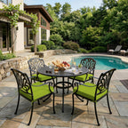 outdoor seat cushions in lime green on black metal patio dining chairs, arranged around a round table beside the backyard pool
