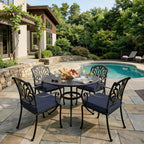outdoor seat cushions in navy blue on black metal patio dining chairs, styled beside a backyard pool with a round outdoor table