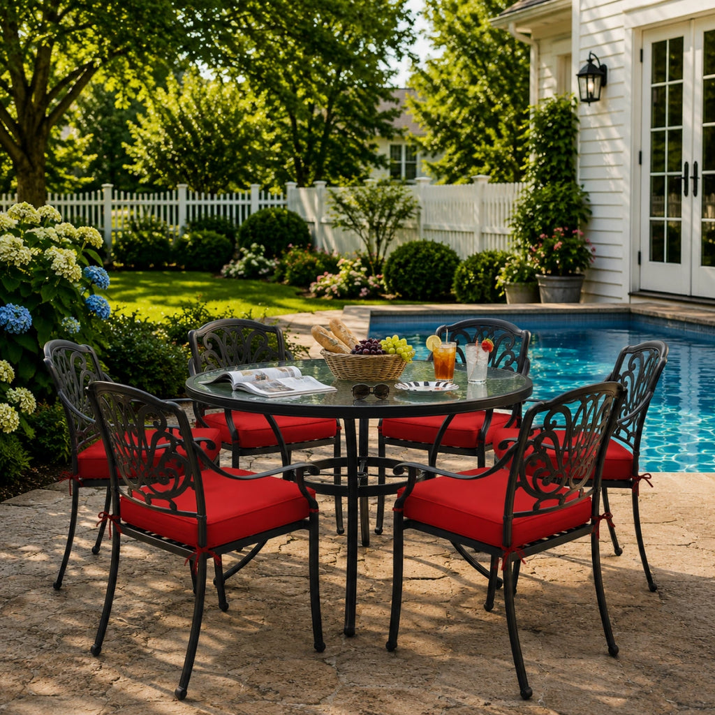outdoor seat cushions in red on black metal patio chairs, styled in a sunny backyard garden with a small round outdoor table