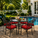 outdoor seat cushions in red on black metal patio chairs, styled in a sunny backyard garden with a small round outdoor table