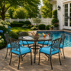 outdoor seat cushions in turquoise on black metal patio chairs, styled in a sunny backyard garden with a small round outdoor table