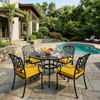 outdoor seat cushions in yellow on black metal patio dining chairs, creating a bright poolside outdoor dining setup