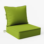 Green cushioned chair on a white background